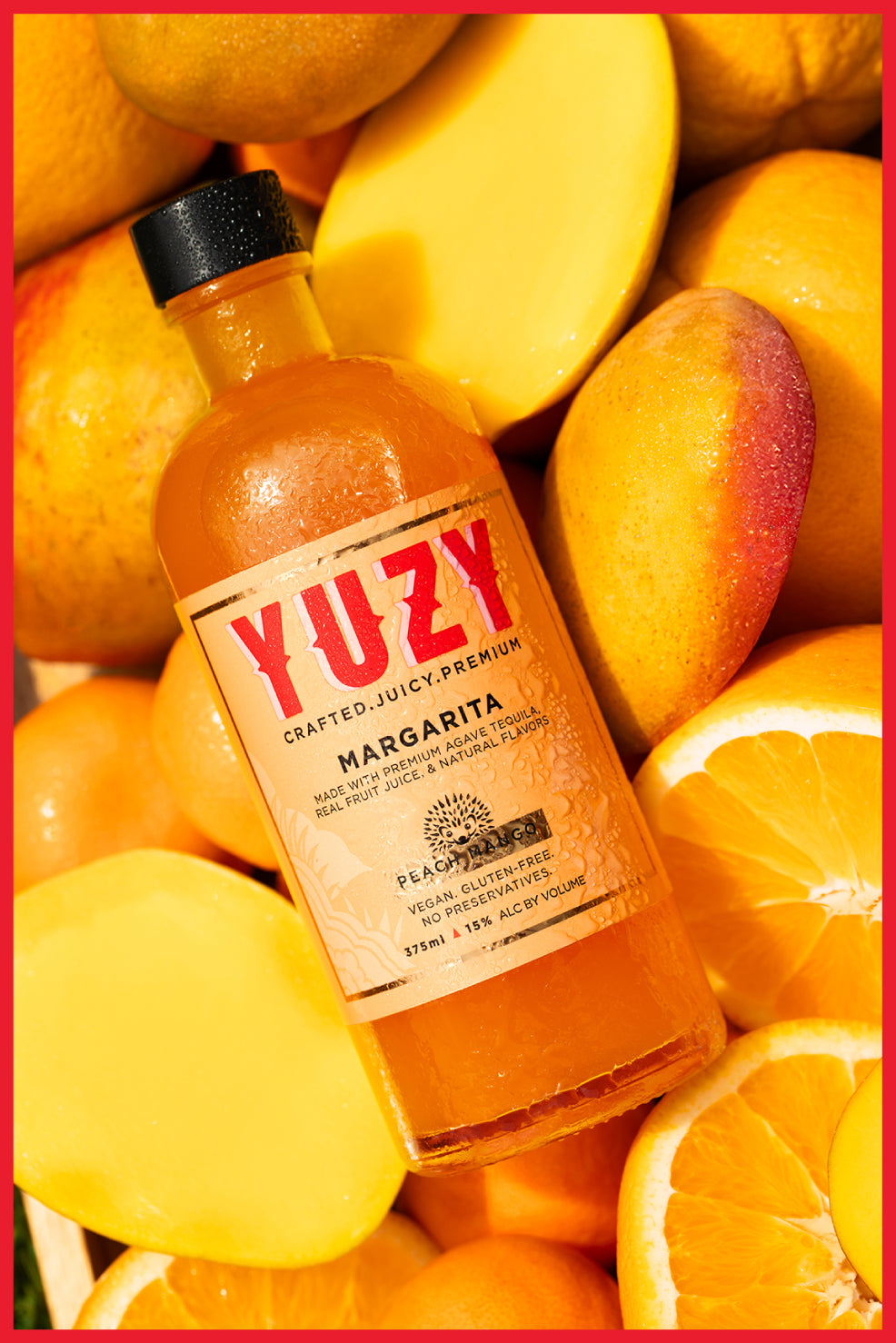 Bottle of YUZY  "Peach Mango" margarita surrounded by fruits as the background with a red border